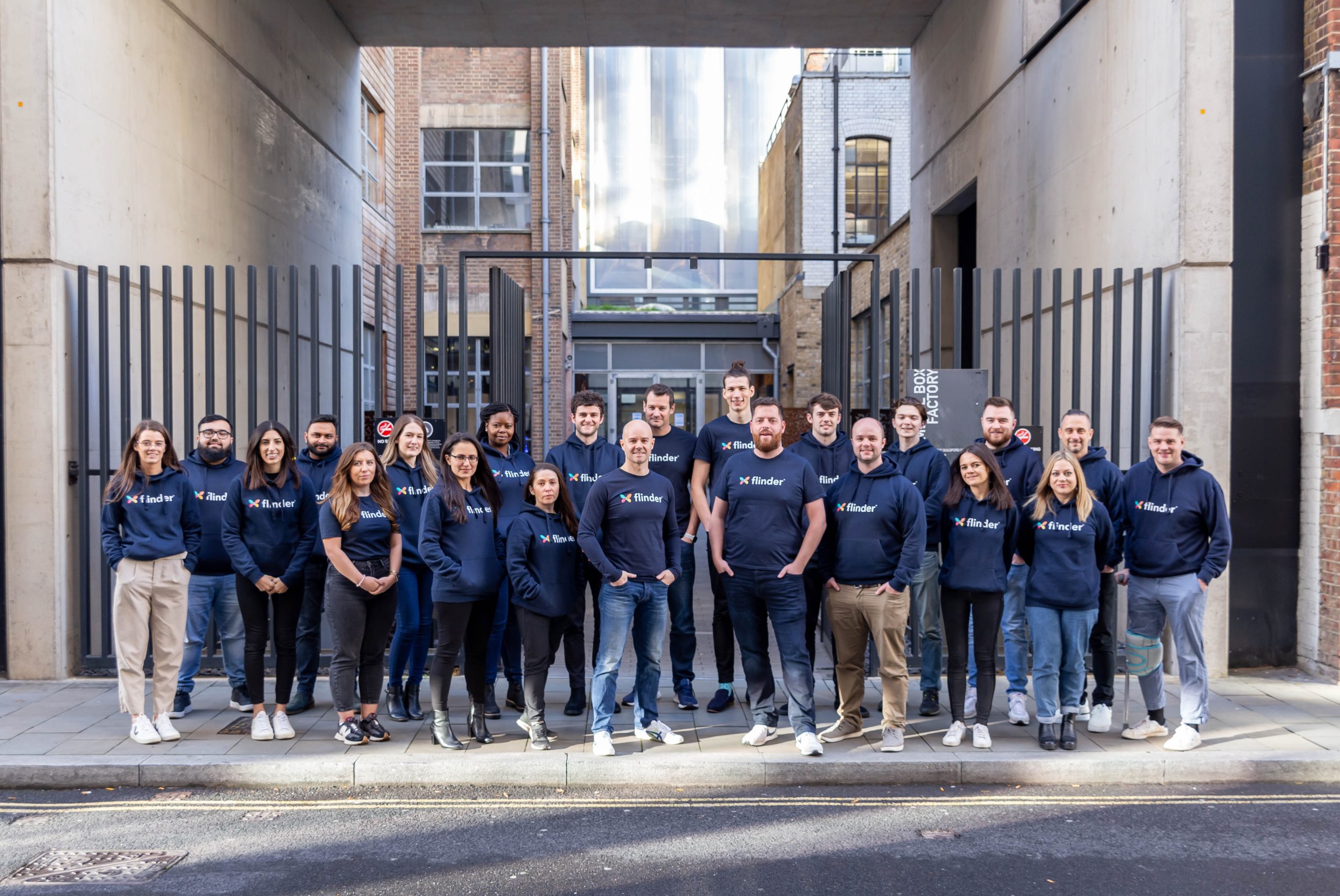 The flinder team standing in front of the office